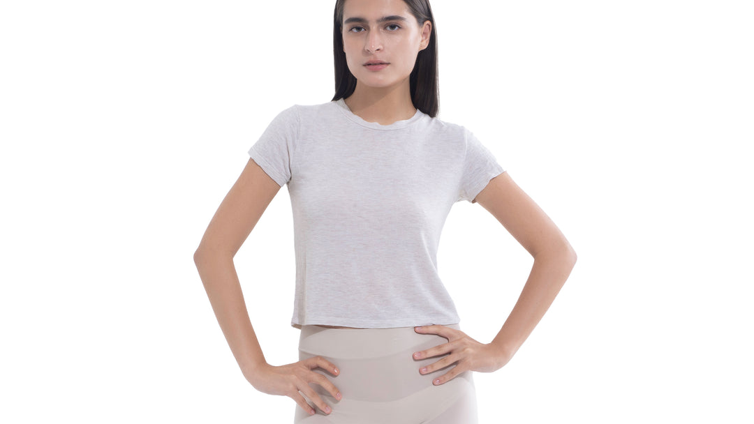 Model in a gray t-shirt and light pants, showcasing discreet protection with Nippetals NipGrips underneath