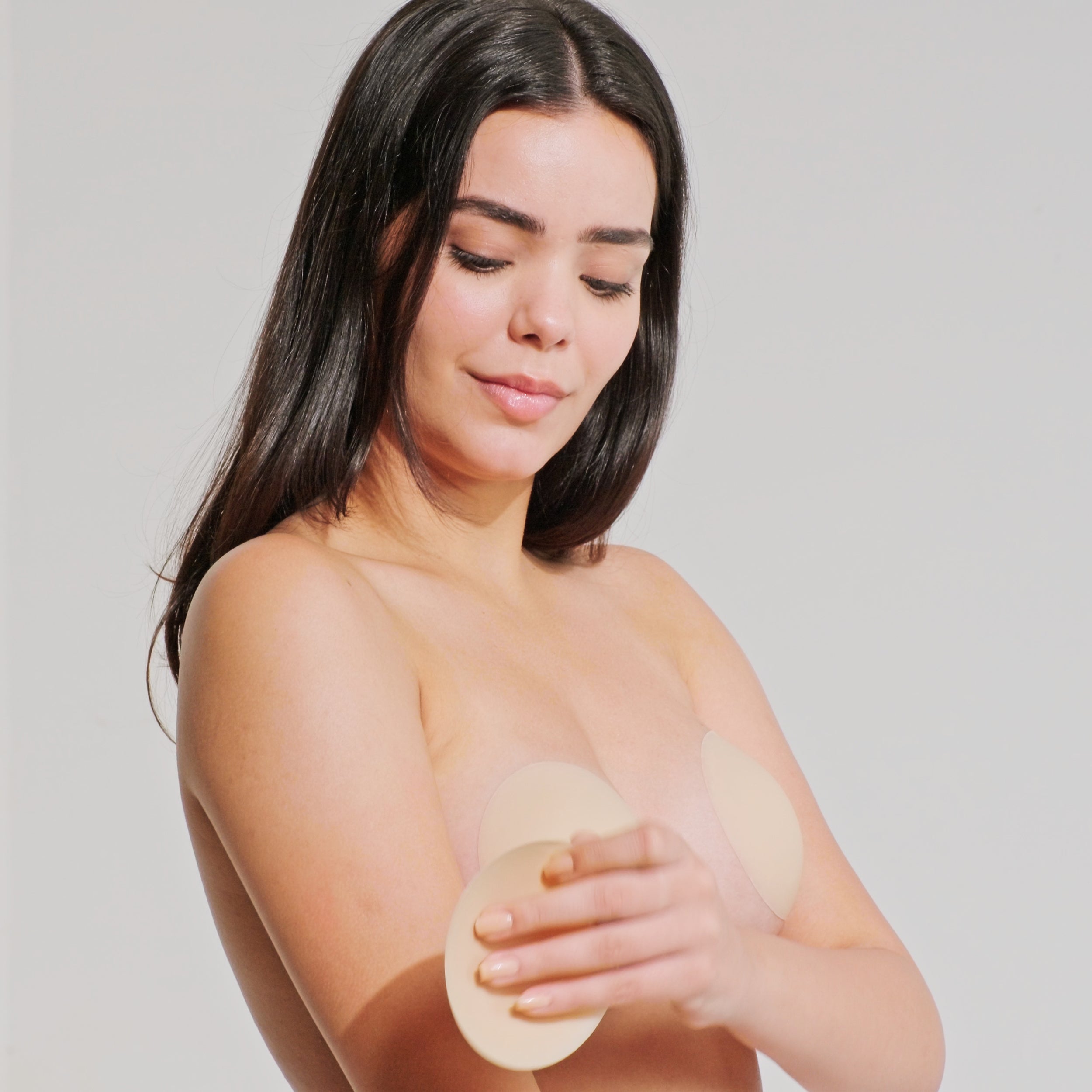 Model posing confidently after removing Nippetals NipSticks adhesive nipple cover, showing natural skin free of irritation and rashes