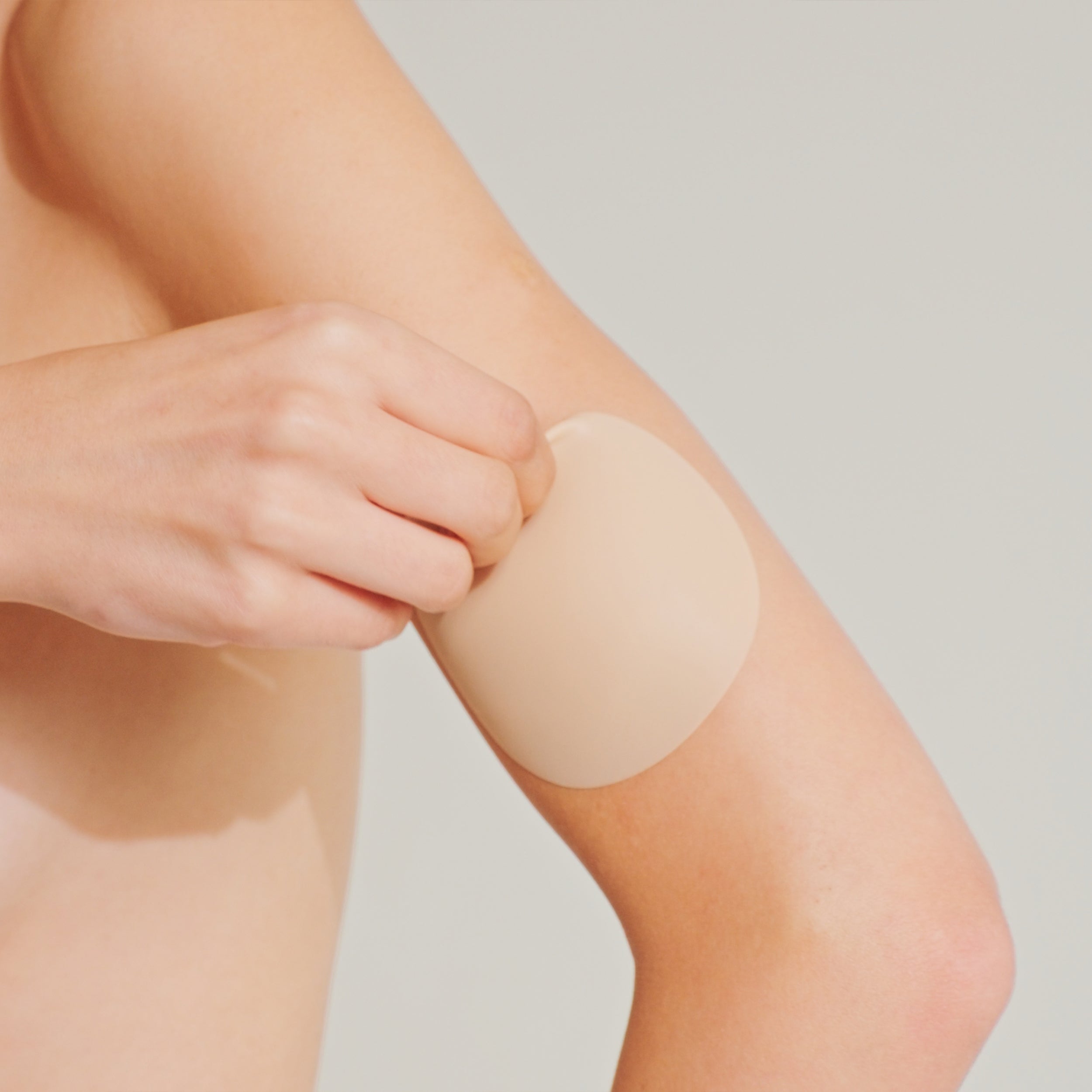 Model starting to peel off Nippetals NipGrips non- adhesive nipple cover gently by holding one edge for easy and safe removal