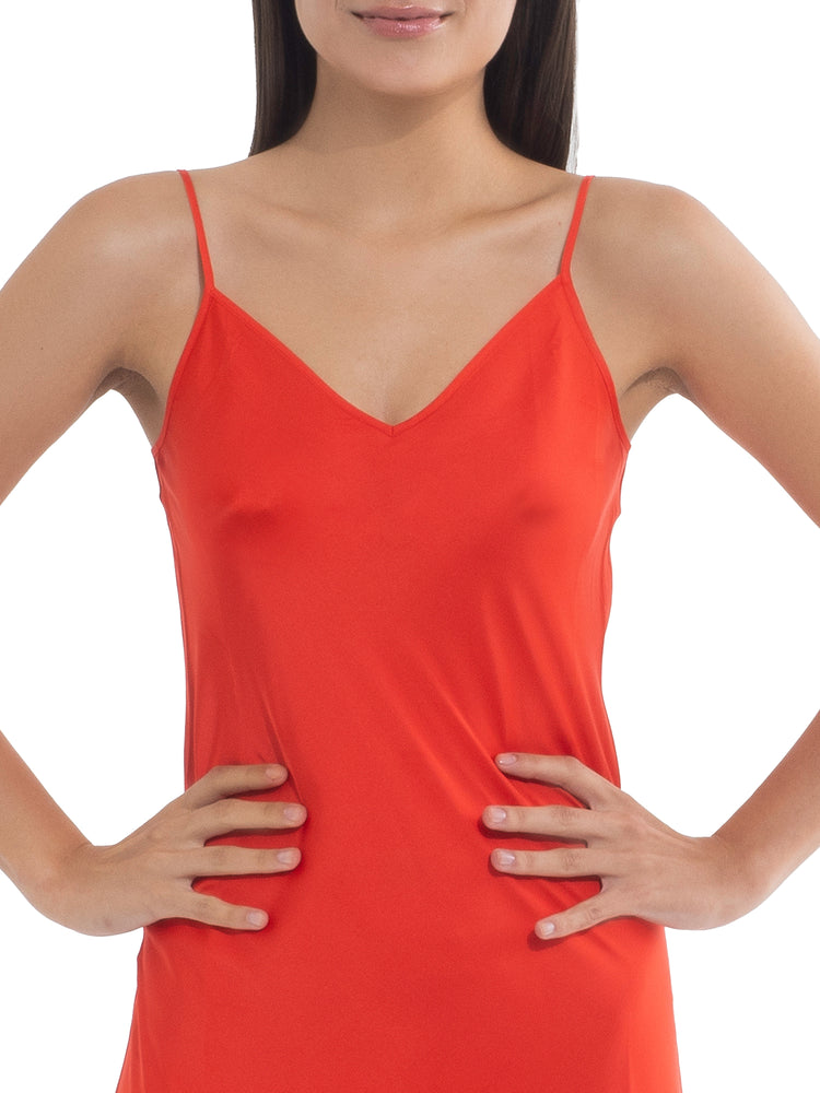 Model in an orange dress, showcasing a natural look with visible nipples before applying Nippetals NipGrips