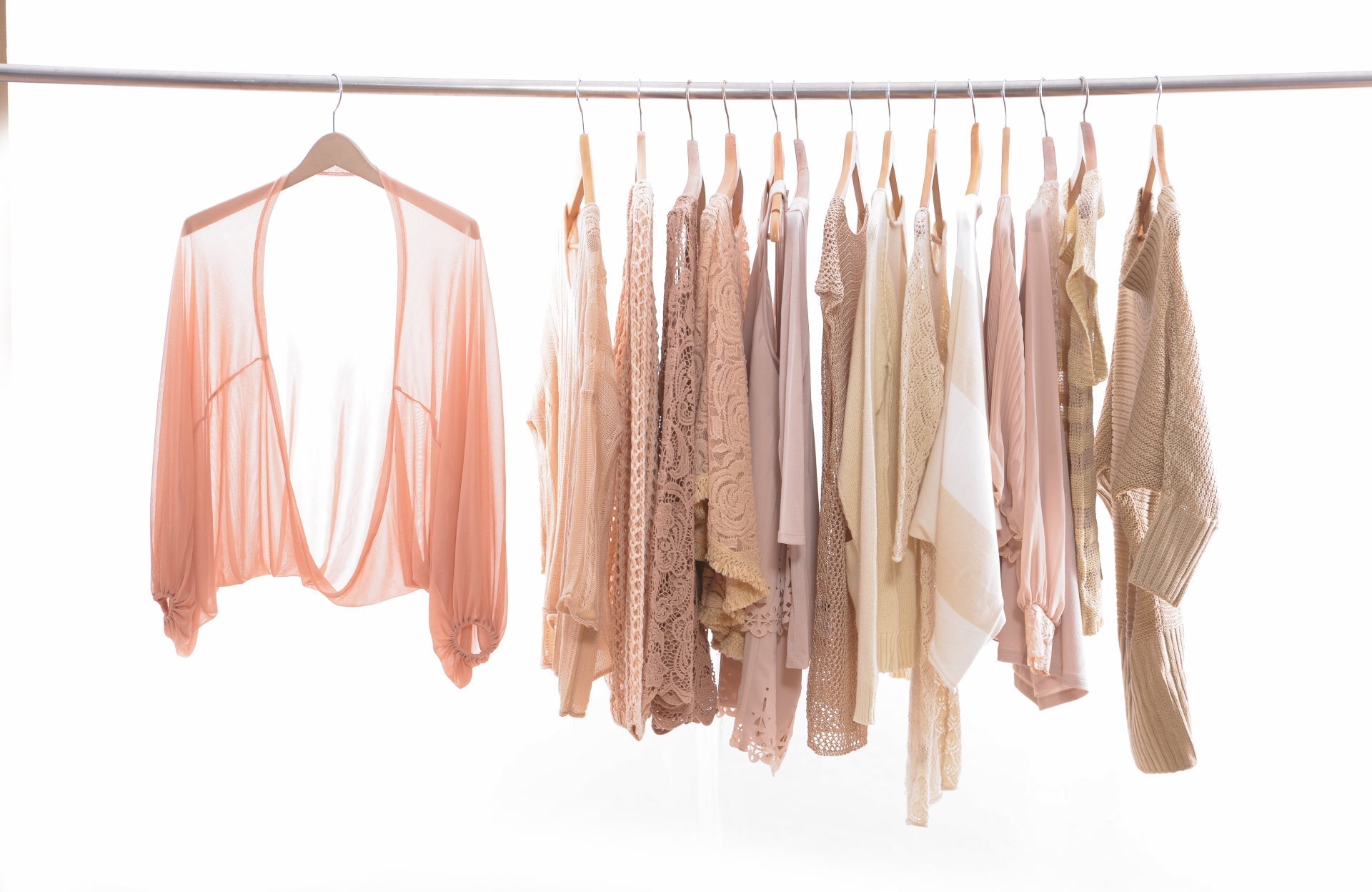 A rack of pastel-colored women's clothing, perfect for pairing with Nippetals solutions, displayed against a clean white background