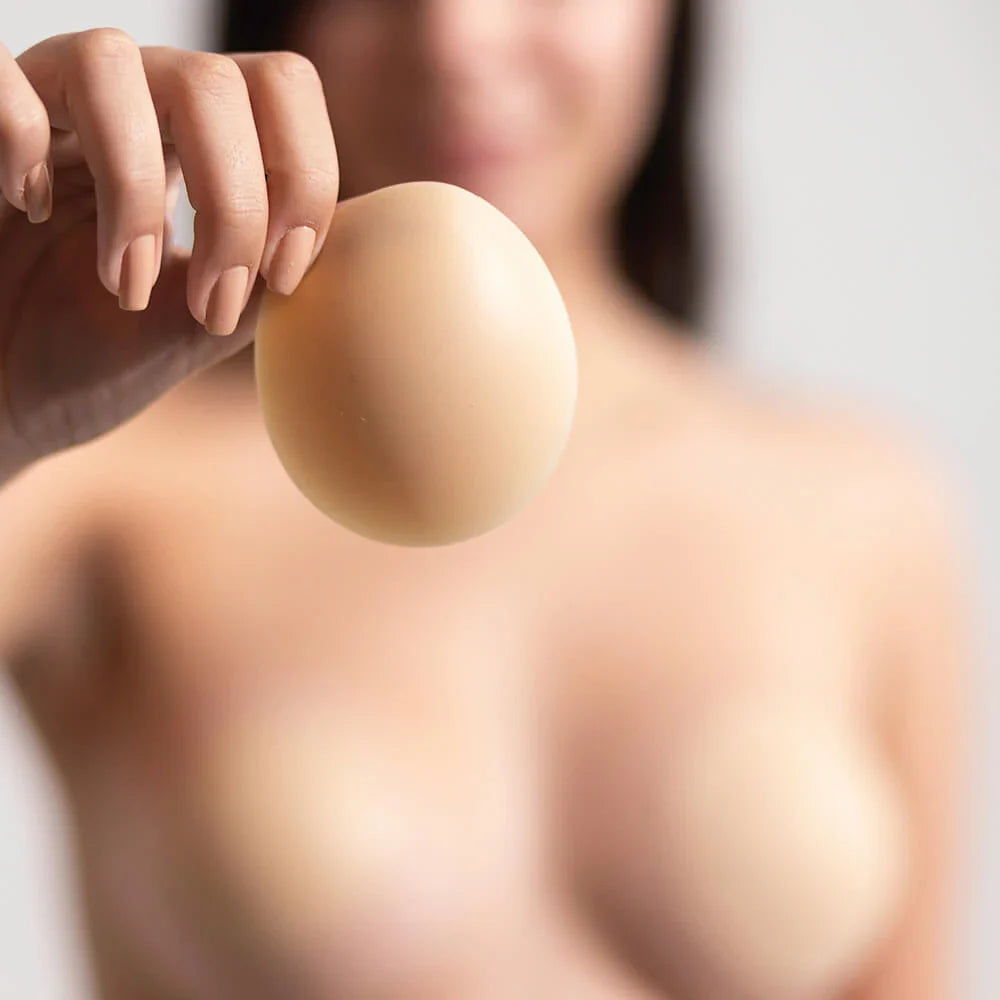 A model holding a Nippetals adhesive nipple cover for a slip proof, discreet experience. Ideal for all-day wear