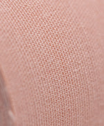 Close-up of textured nude fabric of Nippetals boob tape, featuring a tight knit pattern for enhanced control and comfort